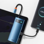 6-in-1 USB-C multiport hub in blue aluminium connected to a laptop and phone